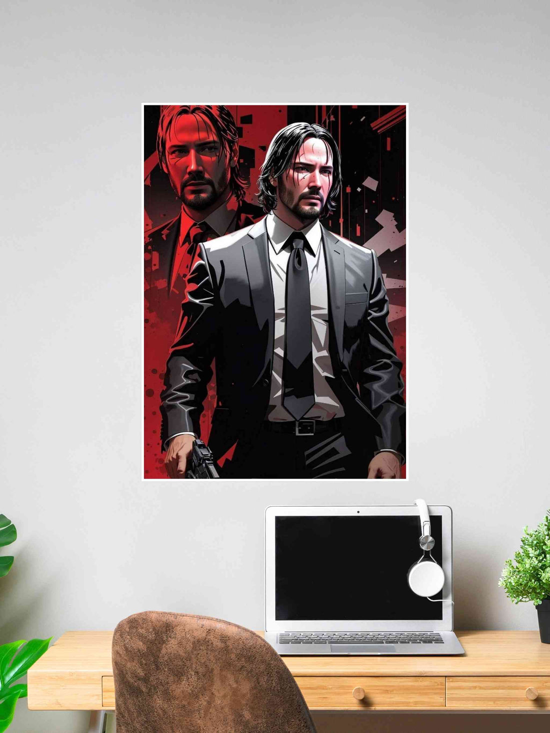Poster of John Wick with a dual portrait design in red and black tones, featuring him in a suit holding a gun, displayed above a desk.