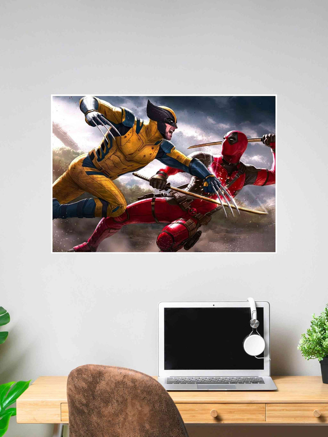 Poster of Wolverine and Deadpool locked in battle, both mid-attack, displayed above a desk in a modern workspace.