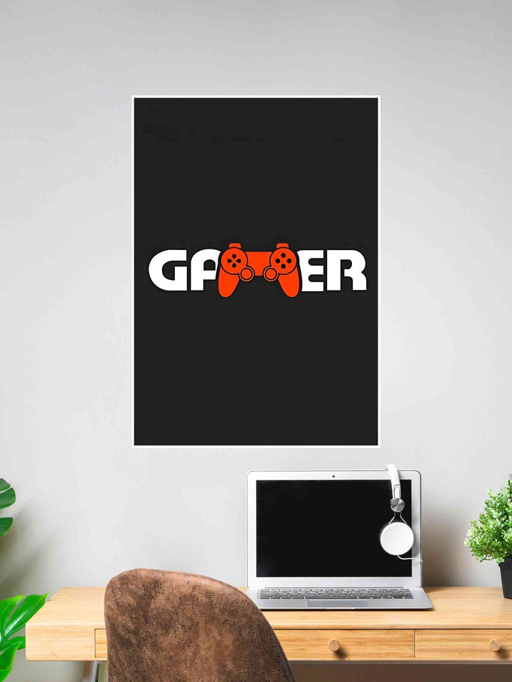 Minimalist black poster with the word “GAMER” in white and a red game controller icon replacing the letter “M”.