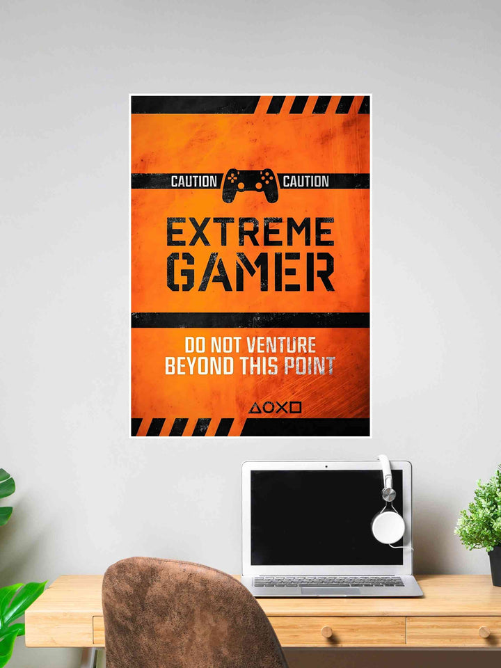 Orange Extreme Gamer poster with black caution tape, a game controller icon, and warning text: "Do Not Venture Beyond This Point."