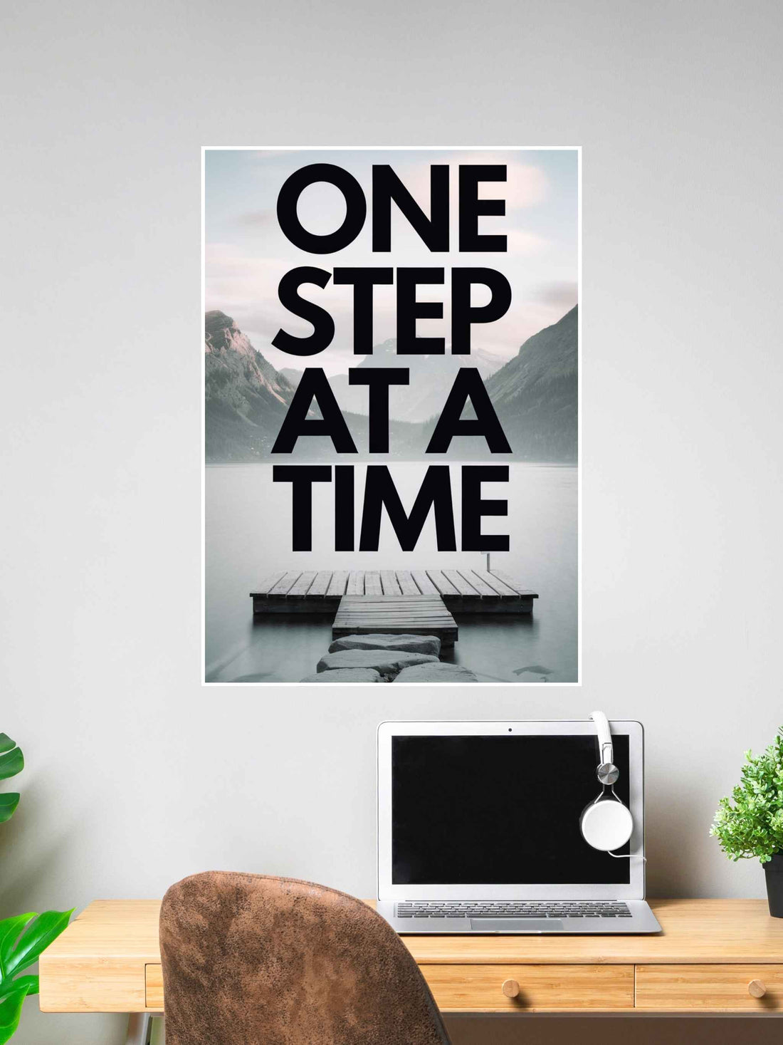 Inspirational wall poster with the words “One Step at a Time” over a peaceful lakeside dock background.