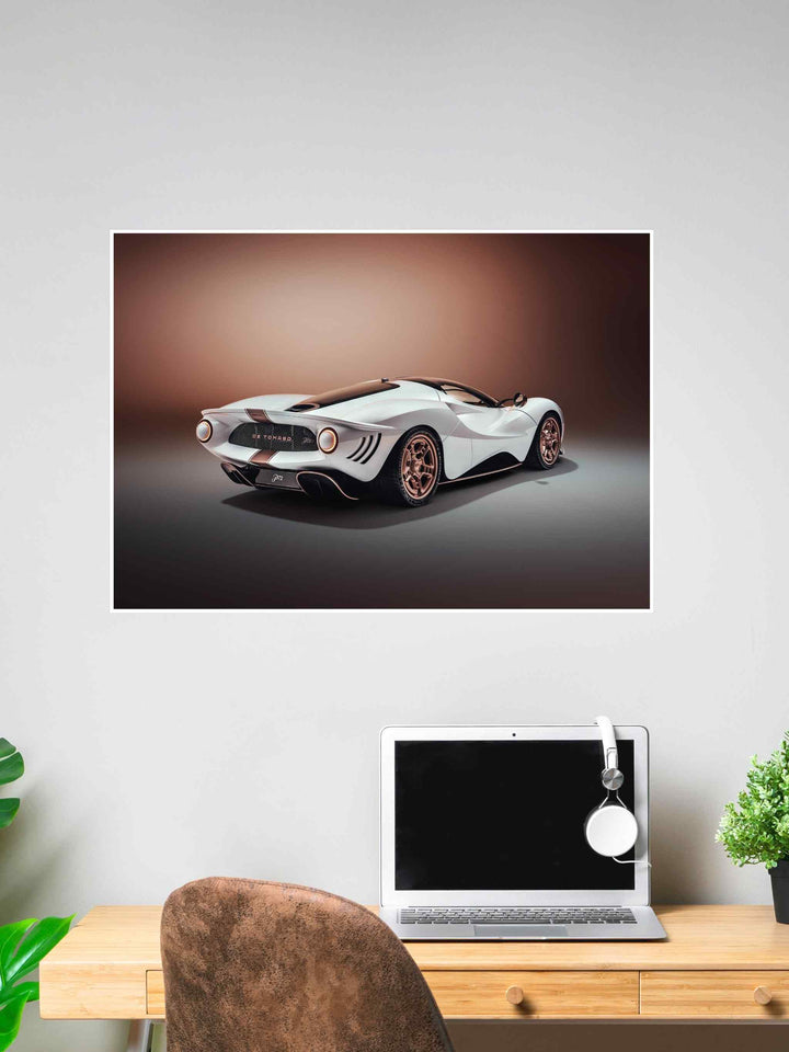 A high-resolution image of a futuristic white De Tomaso P72 supercar with bronze rims, displayed as a poster above a desk.