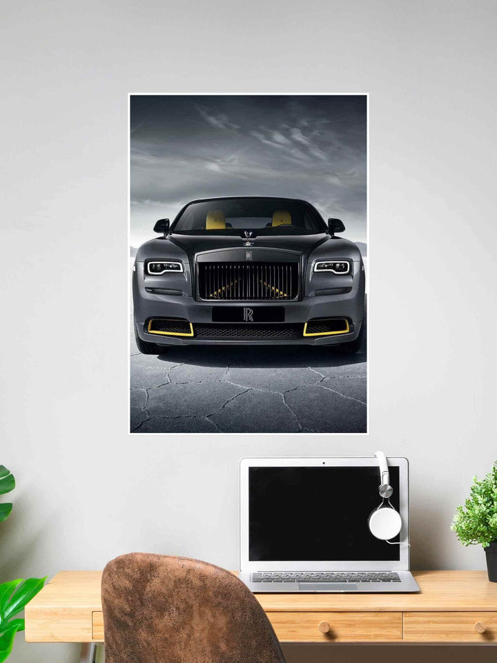 Poster of a sleek black Rolls-Royce with gold accents and yellow interior, photographed front-on against a cracked asphalt background and cloudy sky.